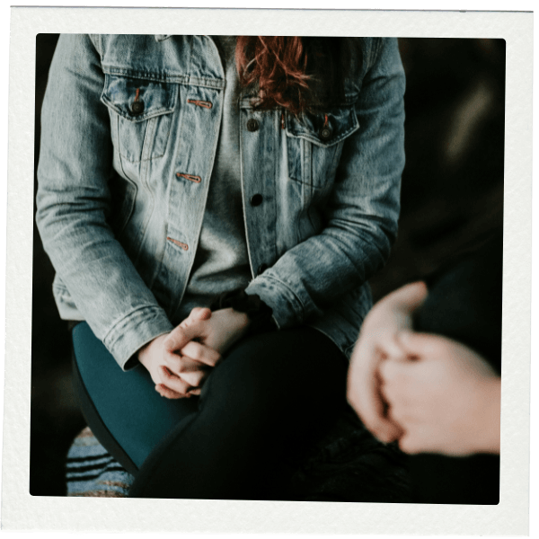Person in a jean jacket seated next to another person